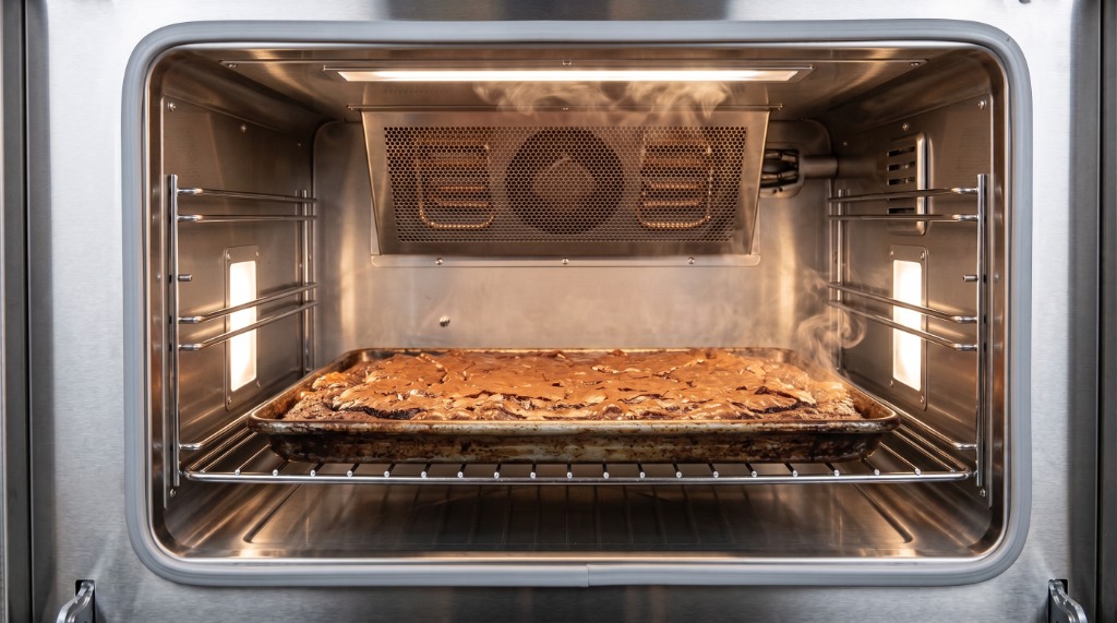 Fresh brownies steaming inside the stainless steel commercial oven at Brooky Treats