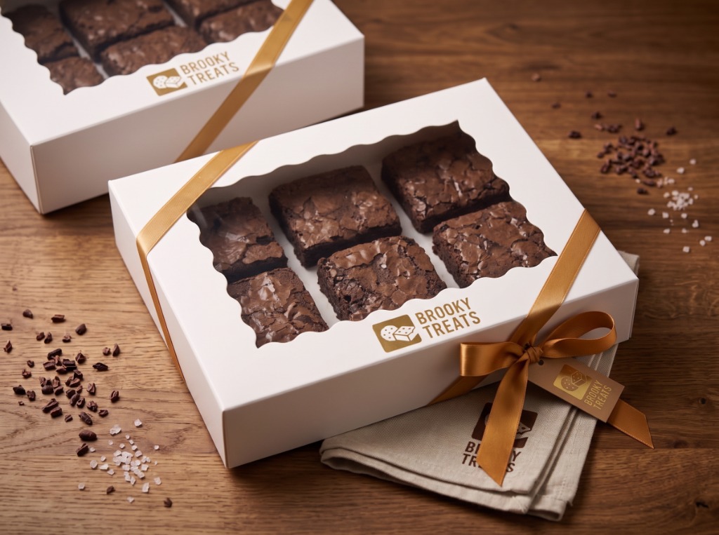 White artisanal gift box with gold ribbon and tag showing 6 brownies